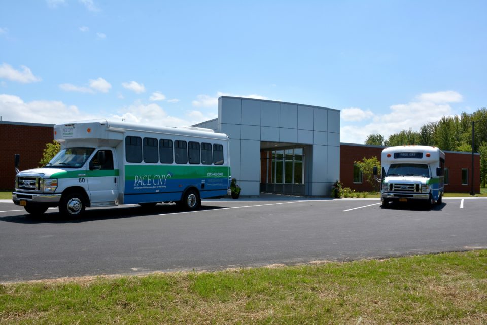 Exterior view of the facility's entrance with shuttle buses
