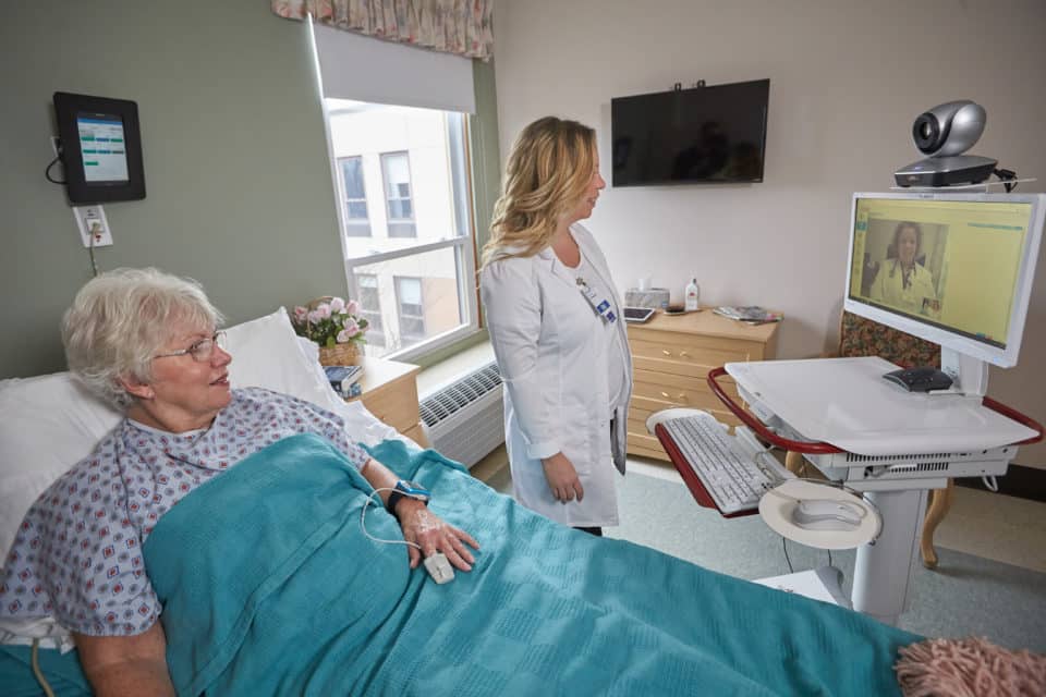 Resident interacting with staff via telehealth