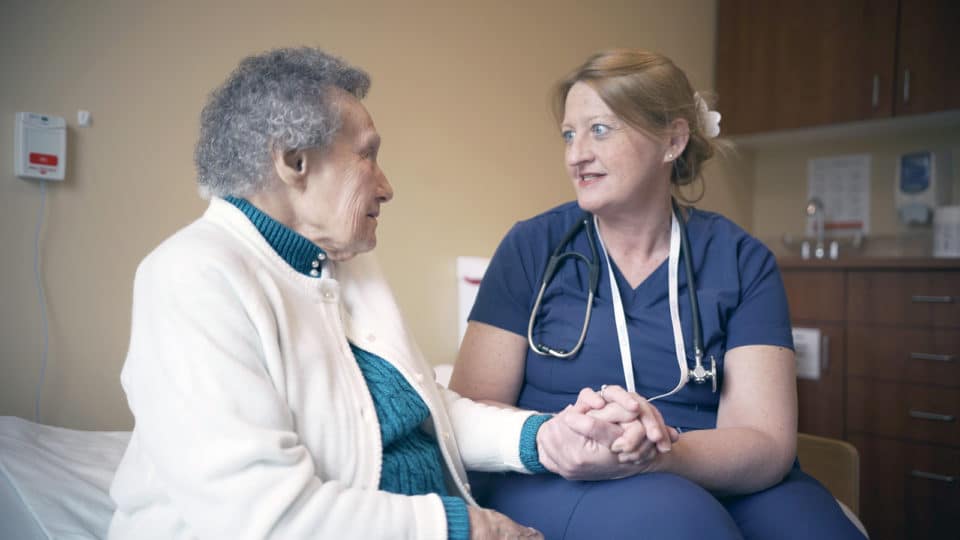 Caregiver interacting with a resident in a private room