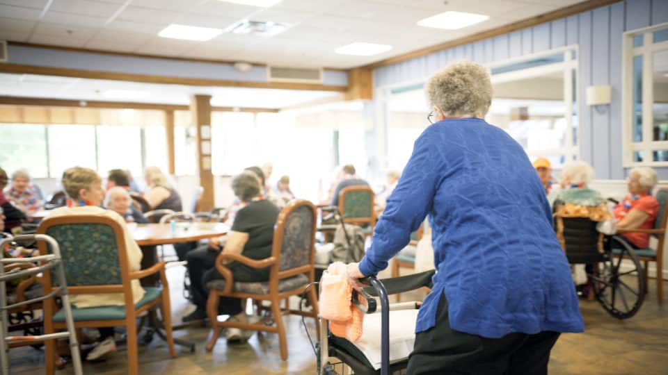 Residents socializing in a common area with activity furniture