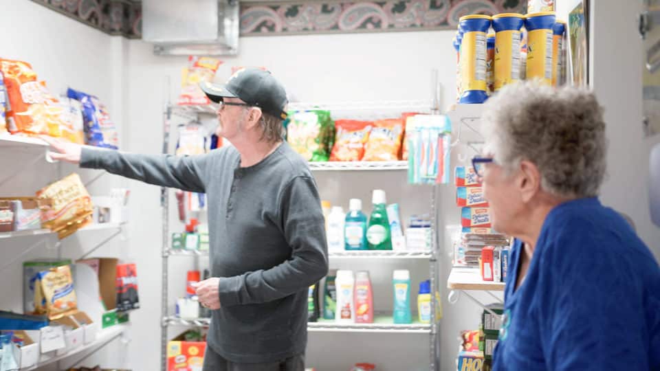 Residents organizing items in a supply room