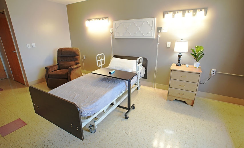 Private resident room with a bed and chair