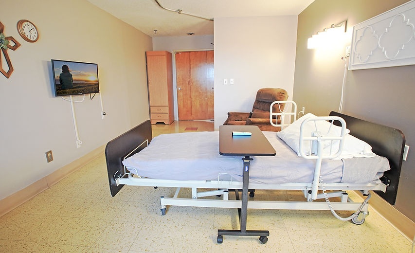 Private resident room with a hospital bed and TV