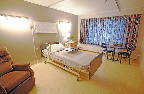 Private resident room with a bed and seating area