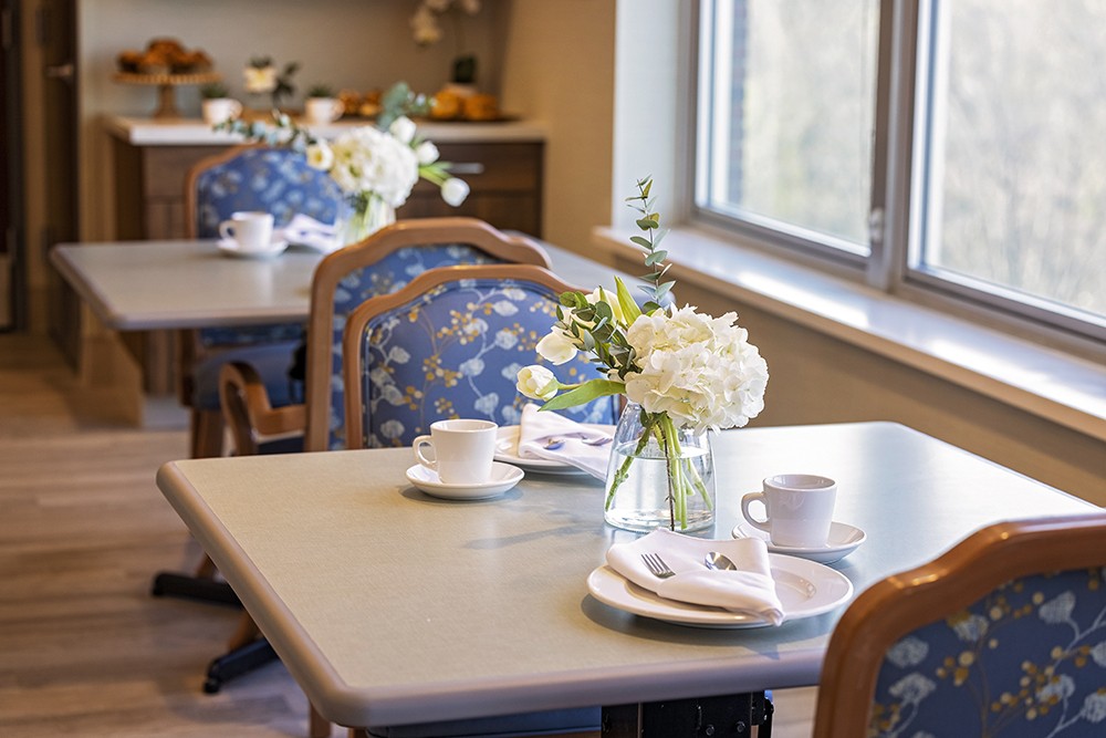 Dining room with floral centerpiece and cups