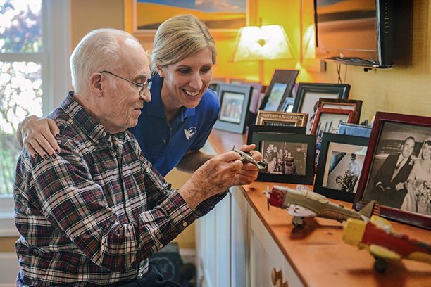 Resident engaging with caregiver over photos