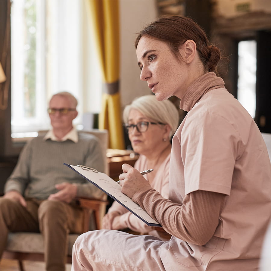 Healthcare staff engaging with residents in a conversation.