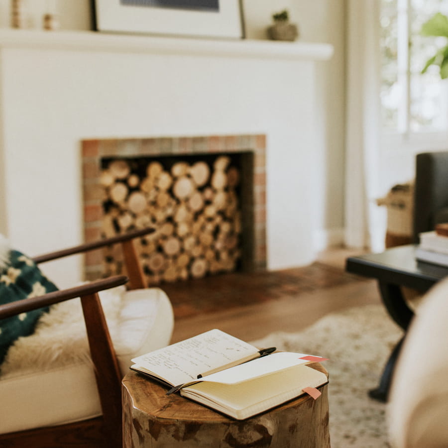 Cozy interior with a notebook on a wooden stool.