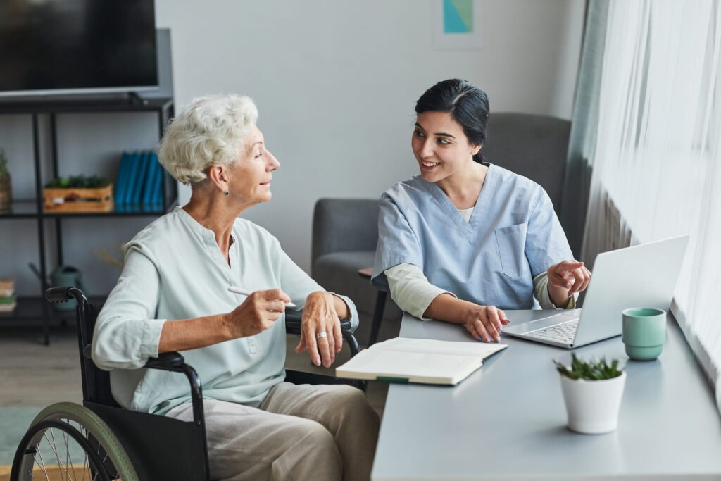 Staff assisting a resident in a cozy interior