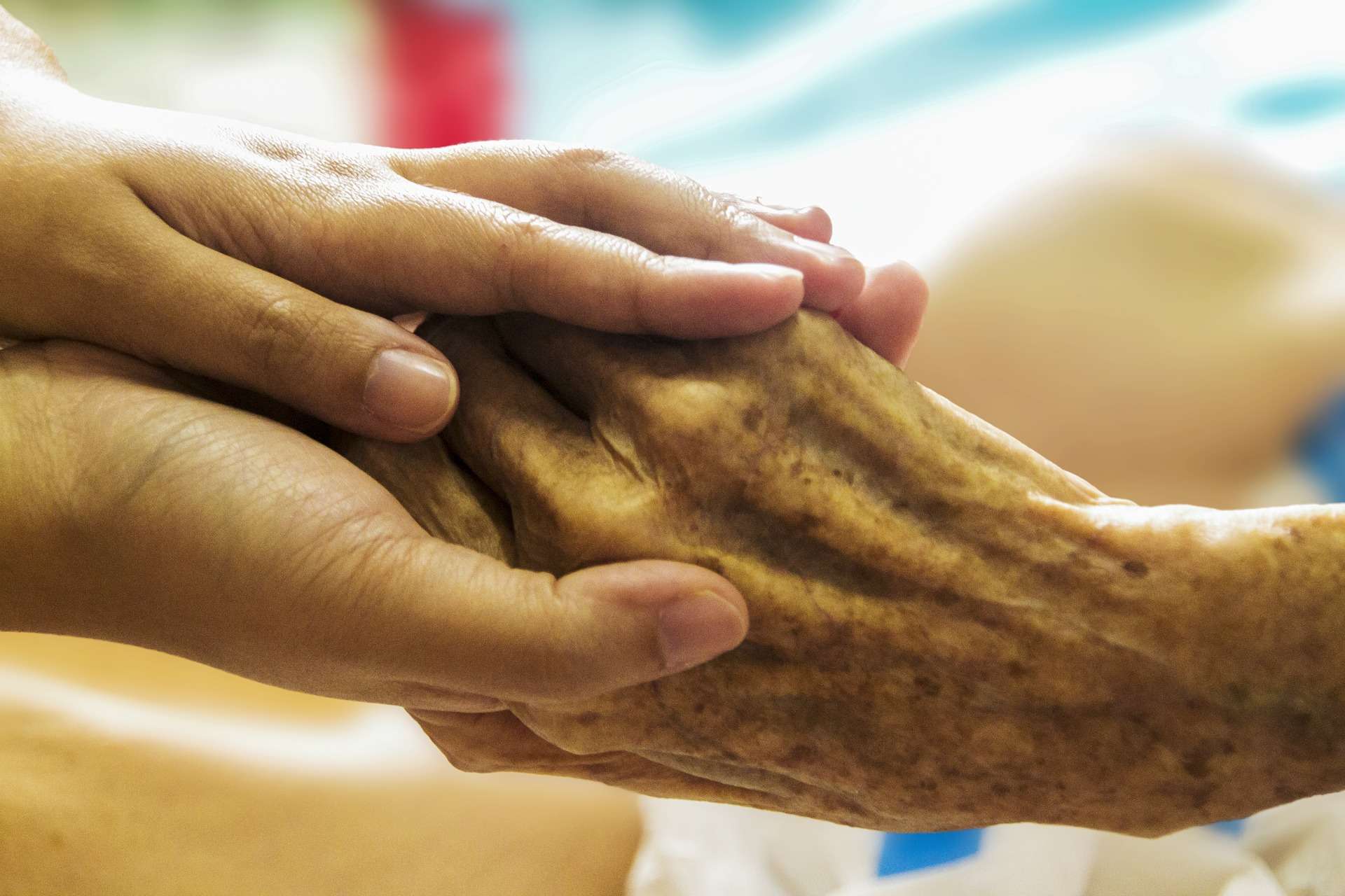 Two hands holding, symbolizing care and compassion.