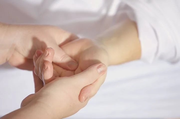 Hands in a caring gesture, depicting assistance.