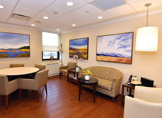 Interior seating area with artwork and a table