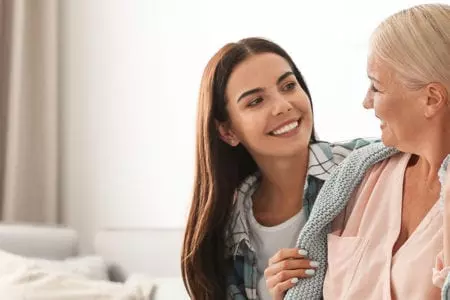 Caretaker and resident sharing a joyful moment