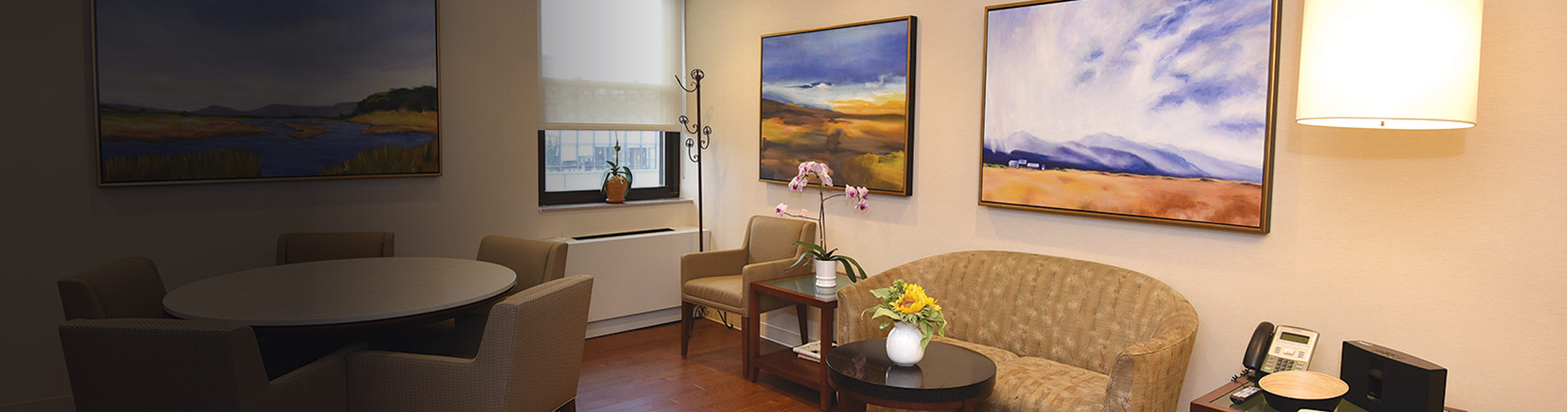 Cozy indoor lounge with artwork and furniture.