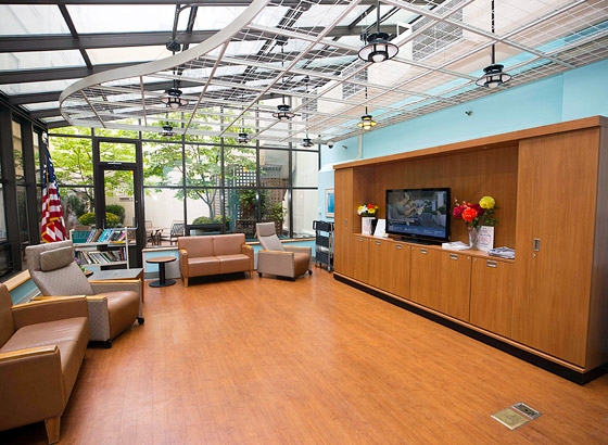 Bright common area with seating and TV.