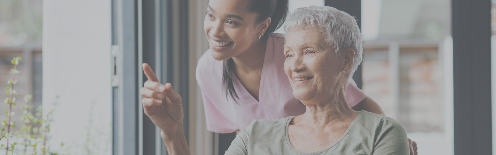 Senior woman with caregiver engaging in conversation.