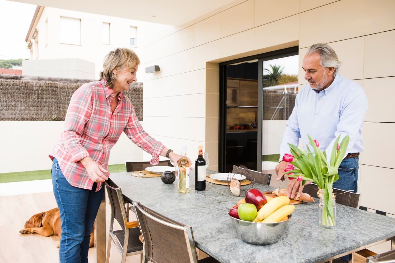 Two residents preparing a meal in an outdoor space.