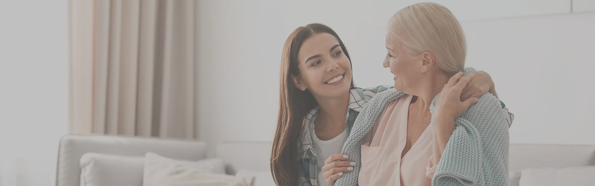 Caregiver interacting warmly with a senior resident.