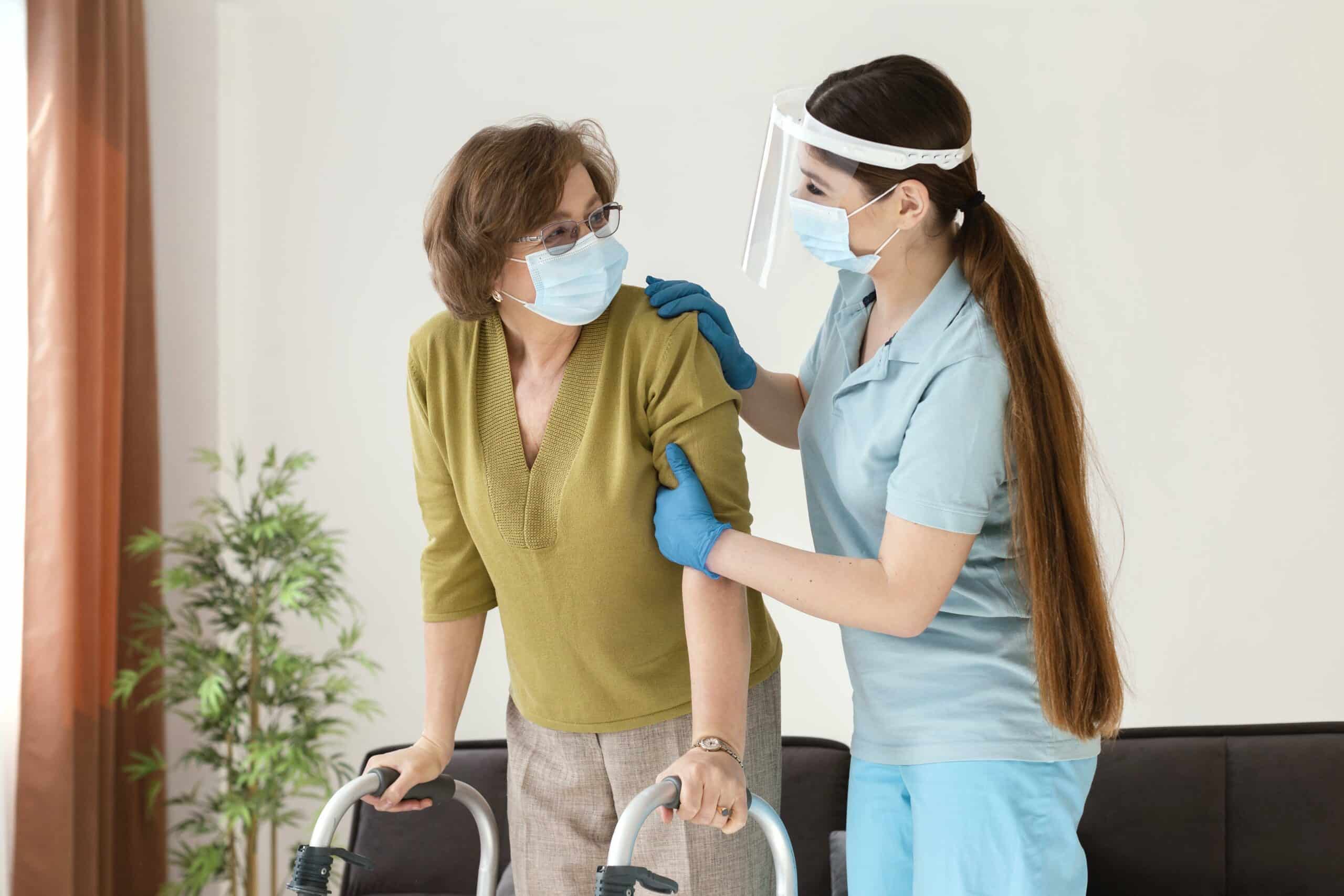 A caregiver assisting a senior resident indoors.