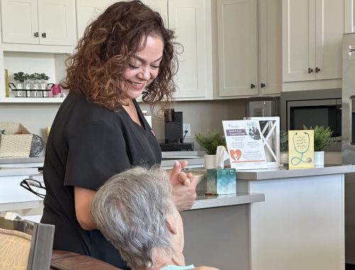 Staff member interacting with a resident in a common area.