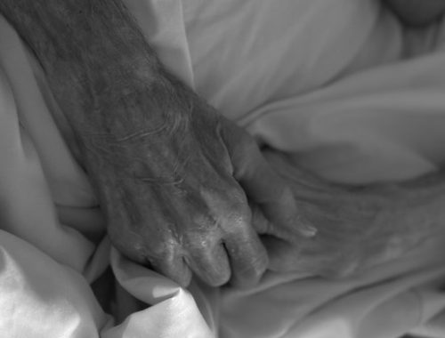 Close-up of elderly hands holding each other