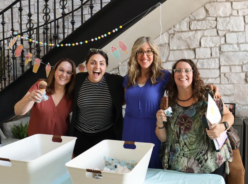 Staff members enjoying ice cream at an event.