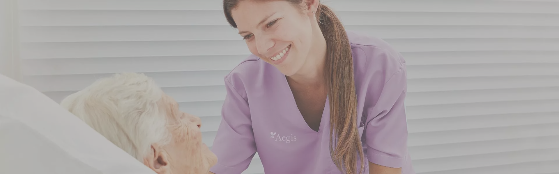 Healthcare worker smiling at elderly resident