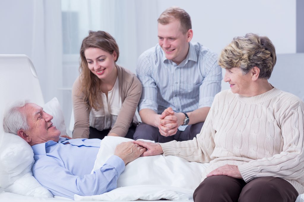 Family visiting a resident in bed