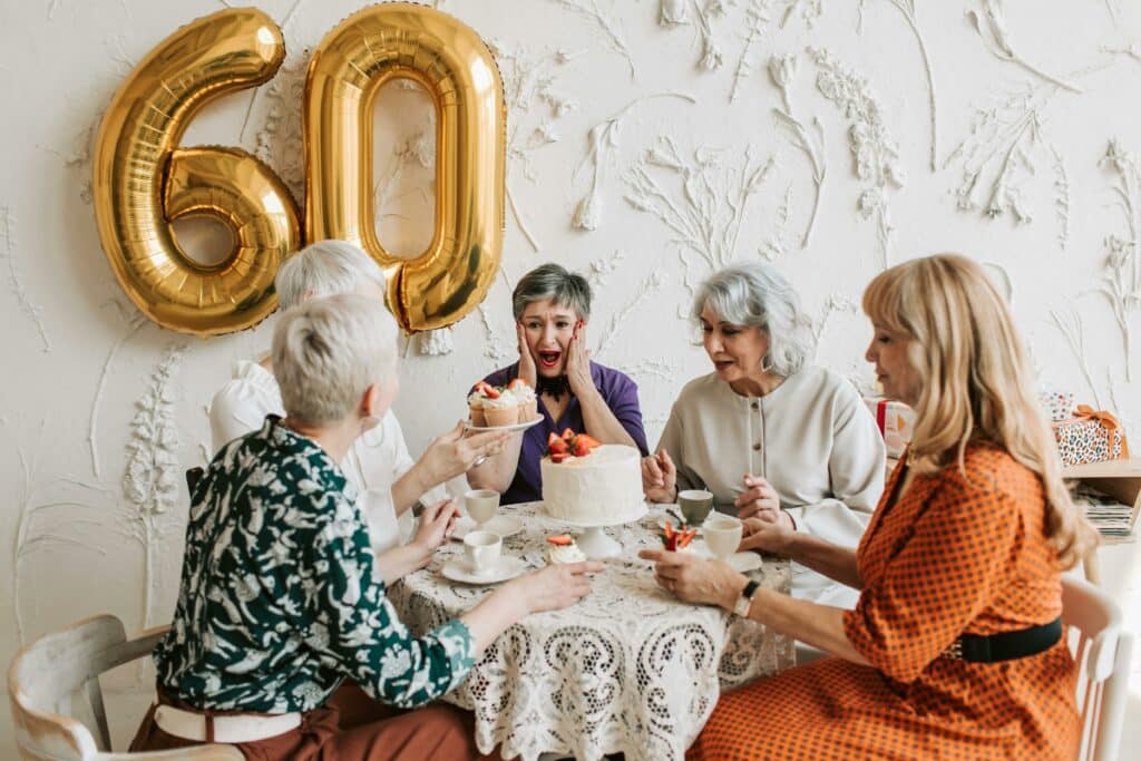 Residents celebrating a 60th birthday with cake.