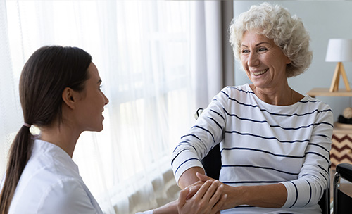 Care staff interacting with a resident in a cozy setting.