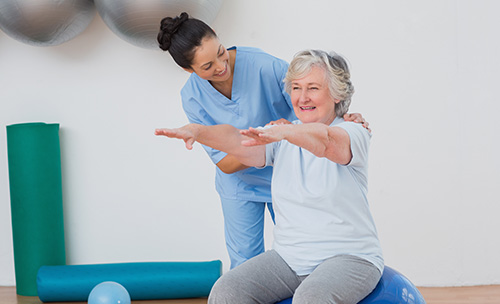 Staff assisting a resident in a fitness activity