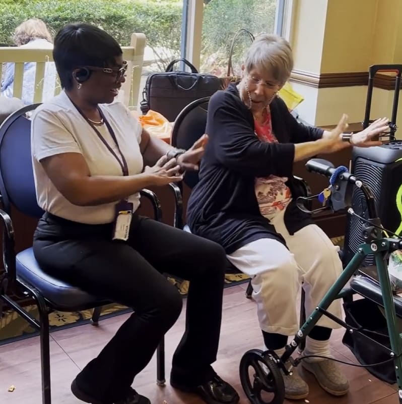 Staff and resident engaging in an activity together.