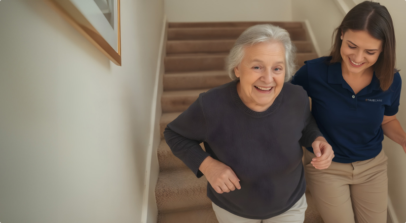 Senior woman climbing stairs with caregiver smiling.