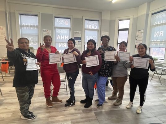 Group of people celebrating achievements with certificates