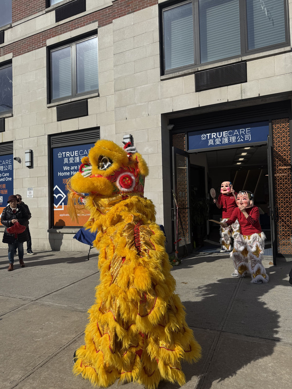 Cultural celebration with lion dancers outside the facility.