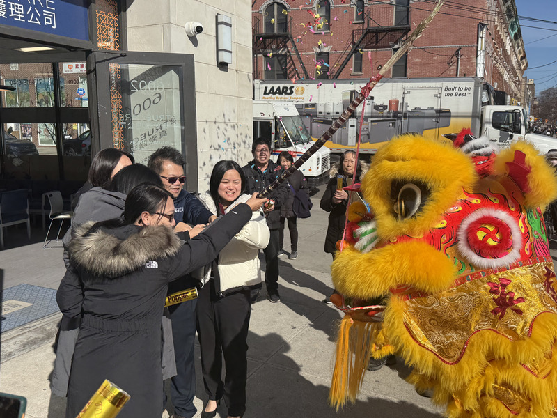 Celebration with a lion dance and participants.