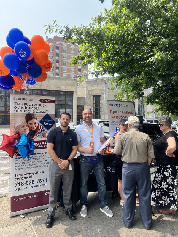 Staff and attendees at a community event with balloons