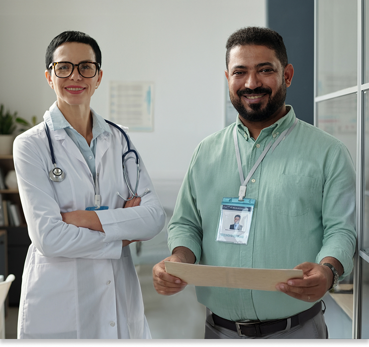 Two healthcare professionals smiling in an office setting.