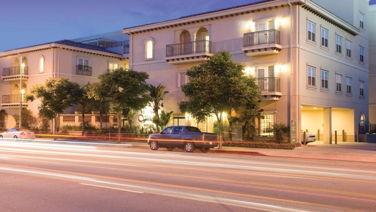 Exterior view of Belmont Village building at twilight.