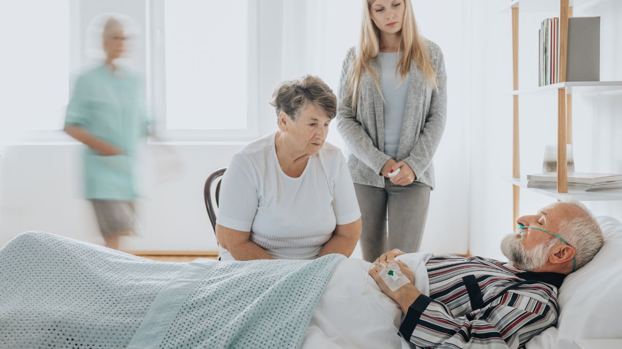 Patient interacting with caregivers in a room