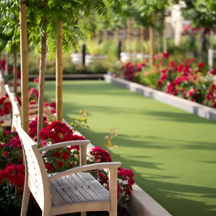 Garden pathway with benches and flowers.