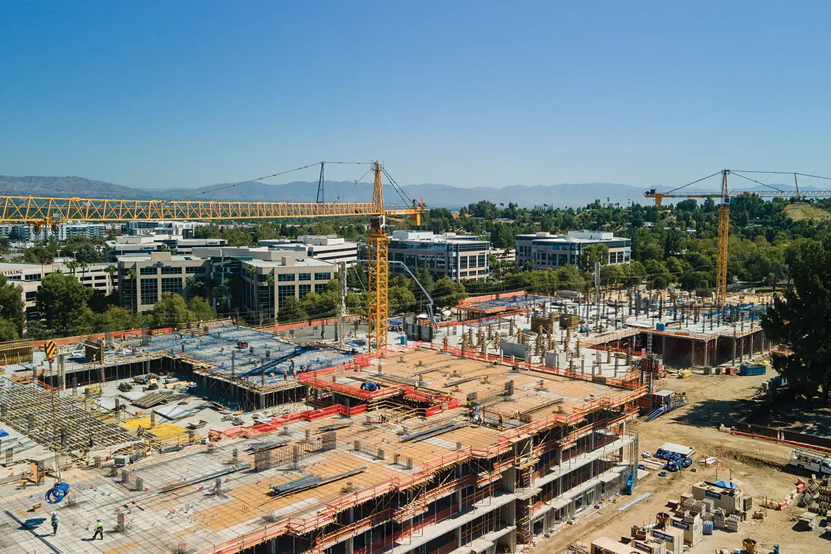 Construction site with cranes and building areas visible.