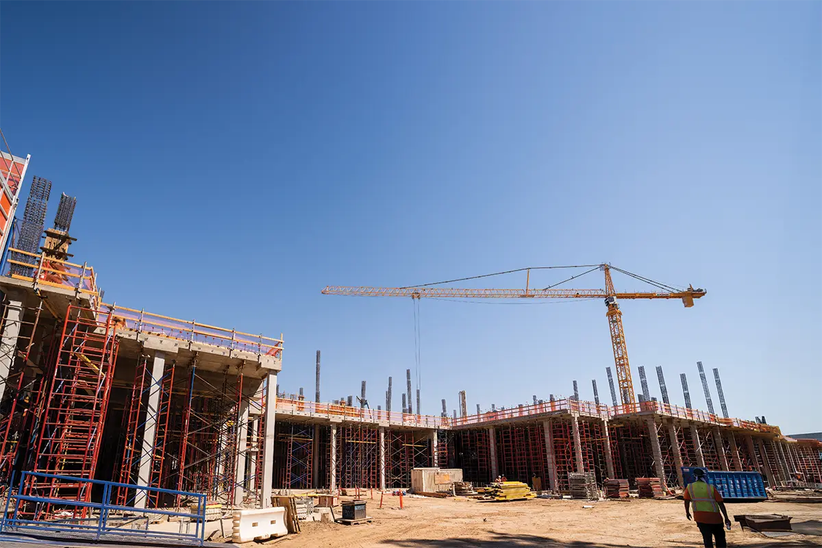Construction site with workers and crane