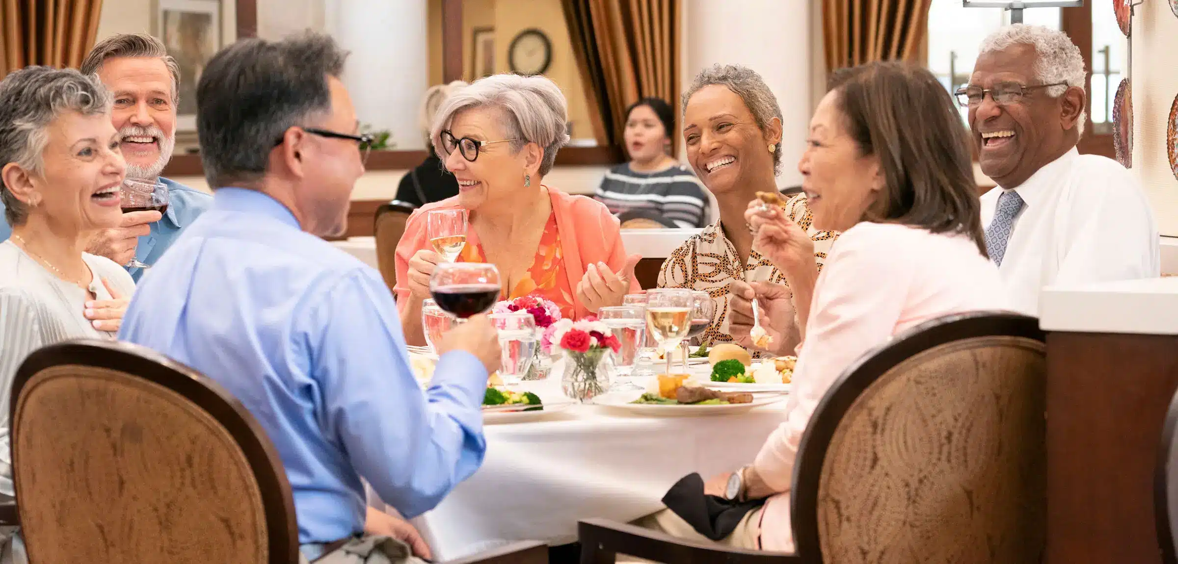 Residents enjoying a meal together at a dining table.