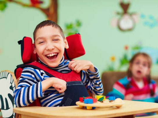 Child laughing while playing with toys