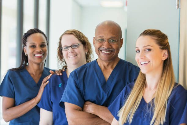 Four staff members in scrubs smiling together