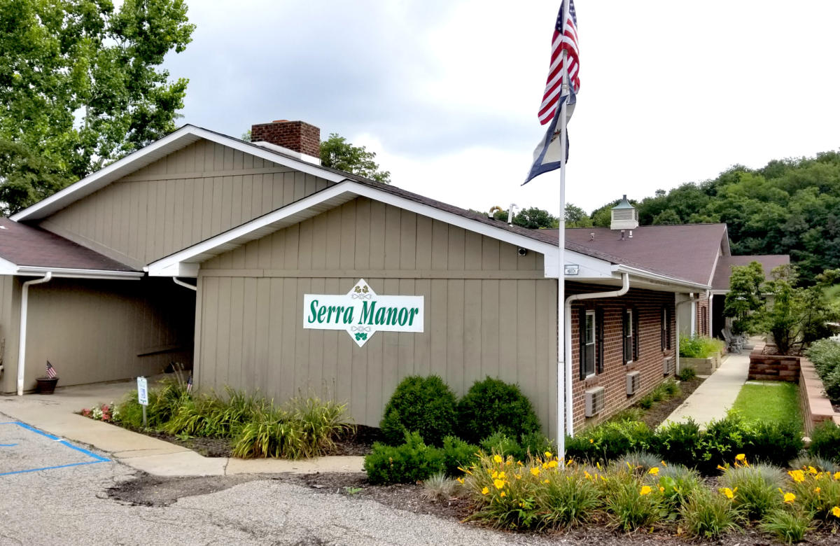 Exterior view of Serra Manor with landscaping.