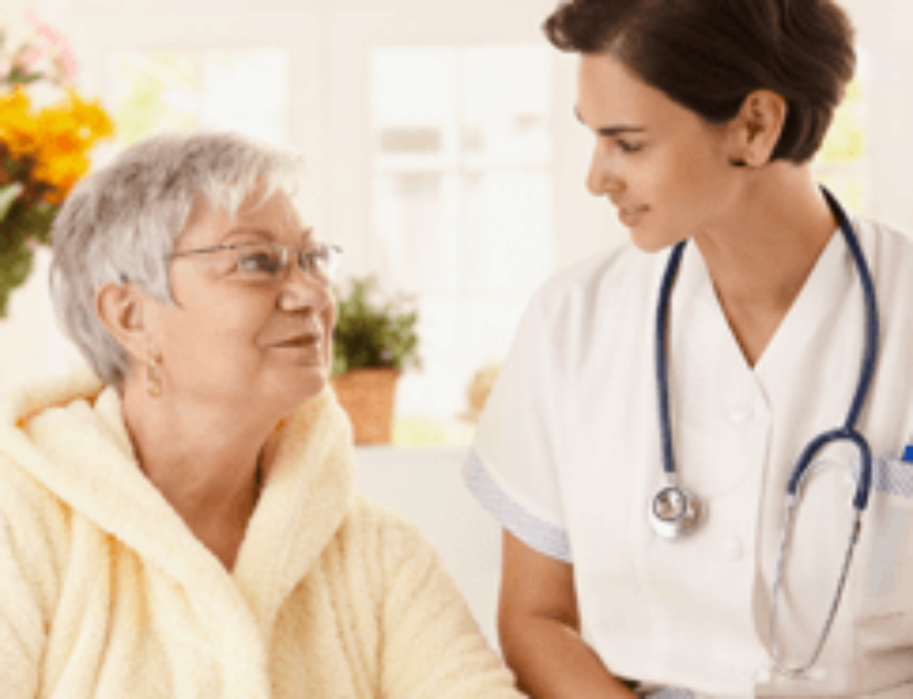 Nurse assisting an elderly resident with care.
