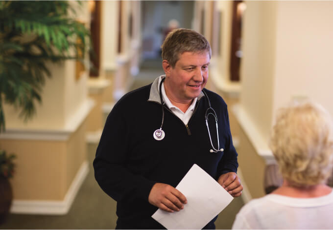 Staff member engaging with a resident in the hall