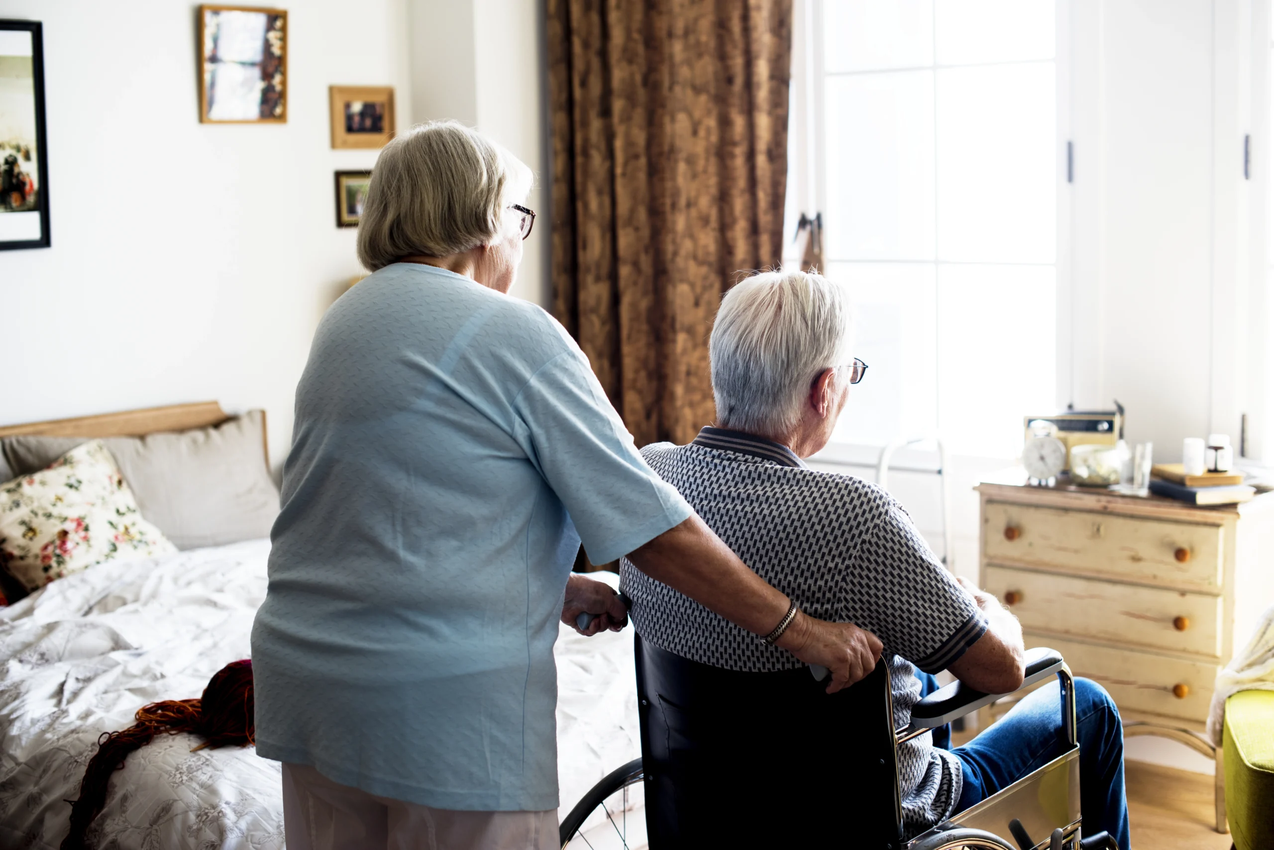 Senior resident being assisted in their room